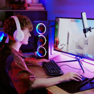 Caucasian Teenager Boy Wearing Headphones Gaming and Streaming Online at Desk